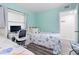 Guest bedroom with twin beds, workspace, and light blue walls at 2700 Ocean Shore Blvd # 317, Ormond Beach, FL 32176