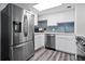 Modern kitchen featuring stainless steel appliances and blue mosaic backsplash at 2700 Ocean Shore Blvd # 317, Ormond Beach, FL 32176