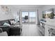 Bright living room with ocean views and gray sectional at 2700 Ocean Shore Blvd # 317, Ormond Beach, FL 32176
