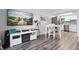 Open living area with large TV, dining table, and kitchen access at 2700 Ocean Shore Blvd # 317, Ormond Beach, FL 32176