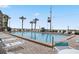 Community pool with ocean view and lounge chairs at 2700 Ocean Shore Blvd # 317, Ormond Beach, FL 32176