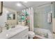 Bathroom with tiled tub and shower, plus storage at 2800 N Atlantic Ave # 212, Daytona Beach, FL 32118