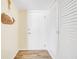 Light and bright entryway with white door and built-in storage at 2800 N Atlantic Ave # 212, Daytona Beach, FL 32118