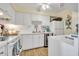 White kitchen with stainless steel appliances and tile countertops at 2800 N Atlantic Ave # 212, Daytona Beach, FL 32118