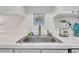 Kitchen sink with tile backsplash and stainless steel faucet at 2800 N Atlantic Ave # 212, Daytona Beach, FL 32118