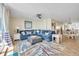Spacious living room with blue sectional sofa, large rug, and ocean view at 2800 N Atlantic Ave # 212, Daytona Beach, FL 32118