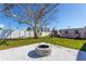 Landscaped backyard with fire pit and patio area at 3263 S Peninsula Dr, Daytona Beach, FL 32118