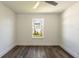 Well-lit bedroom with vinyl plank flooring and a large window at 3263 S Peninsula Dr, Daytona Beach, FL 32118