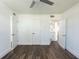 Main bedroom with vinyl flooring, ceiling fan, and access to bathroom and closets at 3263 S Peninsula Dr, Daytona Beach, FL 32118