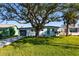 Charming single story home with a large tree in front at 3263 S Peninsula Dr, Daytona Beach, FL 32118