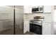 Stainless steel appliances and white cabinetry in the kitchen at 3263 S Peninsula Dr, Daytona Beach, FL 32118