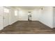 Bright living room with vinyl plank flooring and view into kitchen at 3263 S Peninsula Dr, Daytona Beach, FL 32118