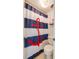 Small bathroom with nautical-themed shower curtain at 3501 S Atlantic Ave # 2030, Daytona Beach, FL 32118