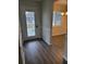 Bright entryway with wood-look floors and view into dining area at 525 E Roberts St, Orange City, FL 32763