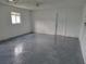 Garage with grey epoxy floor and ceiling fan at 525 E Roberts St, Orange City, FL 32763