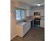 Modern kitchen with white cabinets, stainless steel appliances, and gray countertops at 525 E Roberts St, Orange City, FL 32763