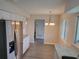 Modern kitchen with white cabinets, stainless steel appliances, and gray countertops at 525 E Roberts St, Orange City, FL 32763