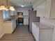 Modern kitchen with white cabinets, stainless steel appliances, and gray countertops at 525 E Roberts St, Orange City, FL 32763
