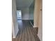 Living room with gray vinyl flooring and a mirrored wall at 525 E Roberts St, Orange City, FL 32763
