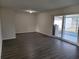 Bright living room featuring dark gray vinyl flooring and sliding glass doors at 525 E Roberts St, Orange City, FL 32763