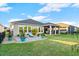Landscaped backyard with patio and access to the lake at 588 Mosaic Blvd, Daytona Beach, FL 32124