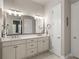 Double vanity bathroom with modern finishes and a large mirror at 588 Mosaic Blvd, Daytona Beach, FL 32124