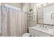 Clean bathroom with a shower/tub combo, modern vanity, and geometric patterned shower curtain at 588 Mosaic Blvd, Daytona Beach, FL 32124