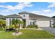 Beautiful two-story home with stone accents and a landscaped yard at 588 Mosaic Blvd, Daytona Beach, FL 32124