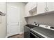 Laundry room with washer, dryer, and cabinets at 588 Mosaic Blvd, Daytona Beach, FL 32124