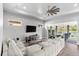 Bright living room with sliding glass doors opening to a patio and water view at 628 Mosaic Blvd, Daytona Beach, FL 32124
