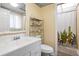 Bathroom features a white vanity, toilet and shower with cactus-themed curtain at 633 S Palmetto Ave # 1010, Daytona Beach, FL 32114