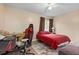 Bedroom with red bedspread and gaming chair at 633 S Palmetto Ave # 1010, Daytona Beach, FL 32114