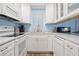 Efficient kitchen with white cabinets, granite countertops, and modern appliances at 633 S Palmetto Ave # 1010, Daytona Beach, FL 32114
