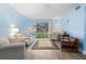 Bright living room with comfy seating and sliding glass doors to the outdoors at 633 S Palmetto Ave # 1010, Daytona Beach, FL 32114