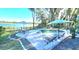 Inviting pool area with patio furniture, lake view, and umbrellas at 1301 Sutton Island Dr, Deland, FL 32724