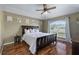 Main bedroom with wood floors, ceiling fan, and large window at 1448 Galena Ter, Deltona, FL 32725