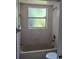 Bathroom with shower/tub combo and single window at 2831 Pike Ln, Deltona, FL 32738