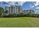 Condo building and lush green surroundings at 3 Oceans West Blvd # 4A5, Daytona Beach Shores, FL 32118