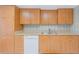 Kitchen with light wood cabinets, granite countertops, and white appliances at 3 Oceans West Blvd # 4A5, Daytona Beach Shores, FL 32118
