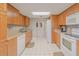 Kitchen with light wood cabinets, granite countertops and white appliances at 3 Oceans West Blvd # 4A5, Daytona Beach Shores, FL 32118