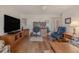Open living area with a home office and large TV at 3 Oceans West Blvd # 4A5, Daytona Beach Shores, FL 32118