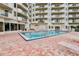 Inviting outdoor pool with plenty of lounge chairs at 3 Oceans West Blvd # 4A5, Daytona Beach Shores, FL 32118