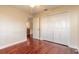 Bedroom with wood floors, double door closet and view of kitchen at 32543 Crystal Breeze Ln, Leesburg, FL 34788