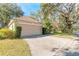 Attached garage with beige walls and a brown roof at 32543 Crystal Breeze Ln, Leesburg, FL 34788