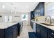 Spacious kitchen with blue cabinetry, marble countertops, and island seating at 33 Sunny Beach Dr, Ormond Beach, FL 32176