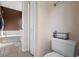 View of a toilet and hallway to bathroom with tub at 3398 Somerset Ave, Deltona, FL 32738