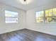 Spacious bedroom with hardwood floors and large windows at 626 N High St, Deland, FL 32720