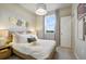 Cozy bedroom with a queen-size bed, wood nightstand, and lovely decor at 4573 Small Creek Rd, Kissimmee, FL 34744