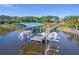 Covered boat dock with seating area on calm water at 3765 John Anderson Dr, Ormond Beach, FL 32176