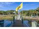 Wooden walkway over water leads to waterfront community at 3765 John Anderson Dr, Ormond Beach, FL 32176